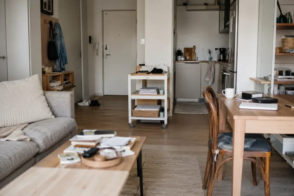 small apartment with minor clutter forming on surfaces showing how small mess can turn into larger clutter over time